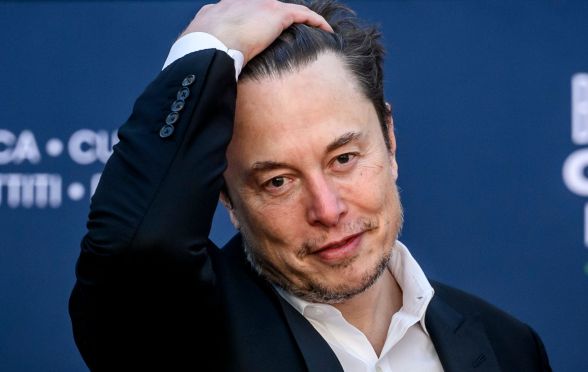 Elon Musk slicking his hair back.