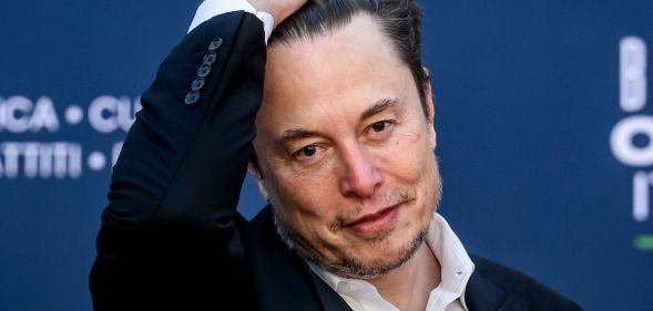 Elon Musk slicking his hair back.