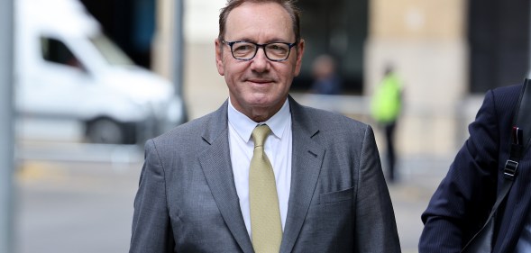 Actor Kevin Spacey arrives at Southwark Crown Court on June 30, 2023 wearing a grey suit and yellow tie