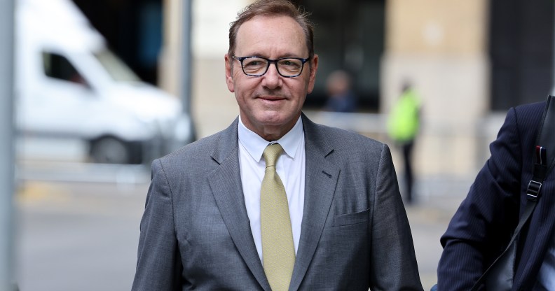 Actor Kevin Spacey arrives at Southwark Crown Court on June 30, 2023 wearing a grey suit and yellow tie