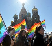 Several activists carry rainbow Pride flags in St Petersburg, Russia