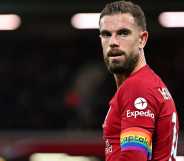 Liverpool player Jordan Henderson wearing a rainbow captain armband