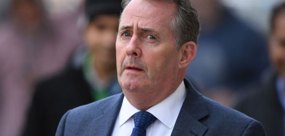 North Somerset MP Liam Fox walks down a busy street.