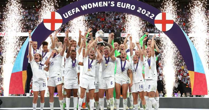 LONDON, ENGLAND - JULY 31: Leah Williamson and Millie Bright of England lift the UEFA Women's EURO 2022 Trophy after their sides victory during the UEFA Women's Euro 2022 final match between England and Germany at Wembley Stadium on July 31, 2022 in London, England. (Photo by Sarah Stier - UEFA/UEFA via Getty Images)