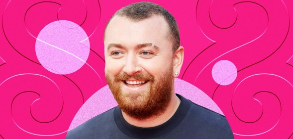 Sam Smith wearing a blue jumper as they smile. They are imposed against a pink background.