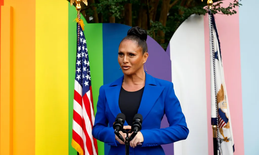 Sasha Colby in a blue suit and black top at Kamala Harris's Pride reception.