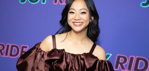 Stephanie Hsu in a poofy brown, off the shoulder dress.