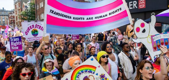 A crowd of people hold up a sign reading "trans rights are human rights" during the 2022 Trans+ Pride event in London.