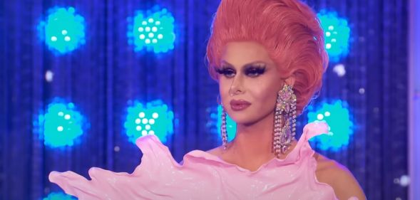 Trinity The Tuck in a plastic pink bodysuit and pink hair on All Stars 4.