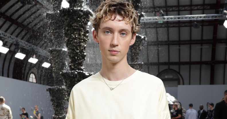 Troye Sivan in a white jumper dress at Paris Fashion Week.