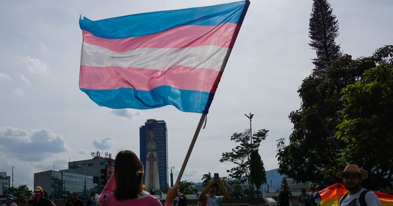 Activist holds trans flag on International Day Against Homophobia, Biphobia and Transphobia on May 20, 2023 in San Salvador, El Salvador