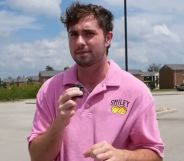A picture of Bo Alford in a car park, wearing a pink shirt.