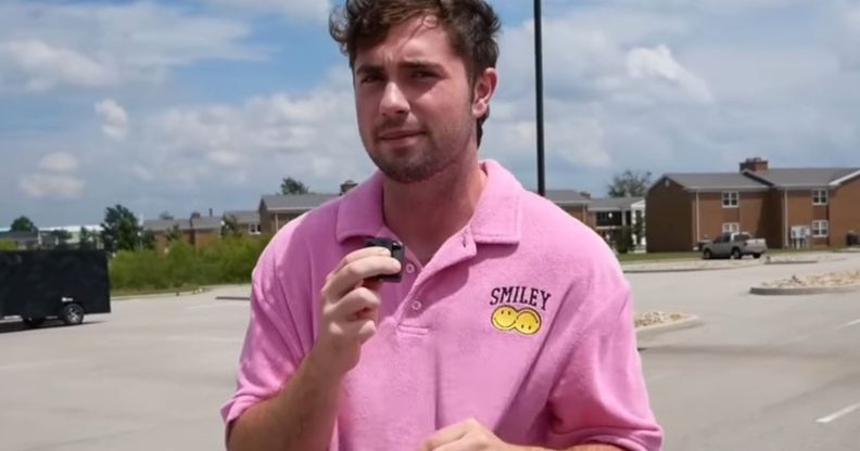 A picture of Bo Alford in a car park, wearing a pink shirt.