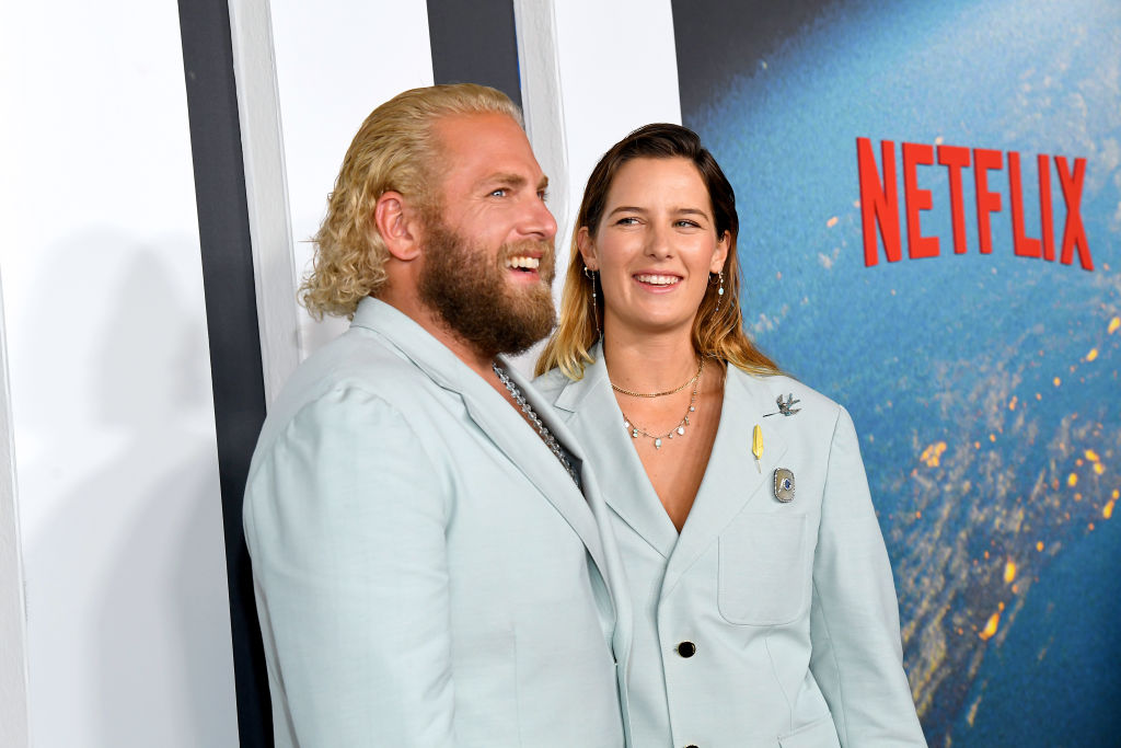 Jonah Hill and Sarah Brady, a white man and woman, wearing matching light blue suits