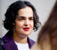 Labour MP Nadia Whittome pictured outdoors doing an interview. She is wearing a purple blazer.