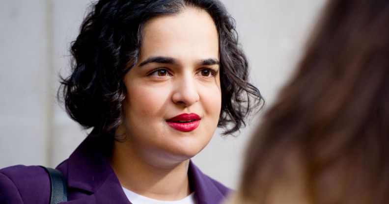 Labour MP Nadia Whittome pictured outdoors doing an interview. She is wearing a purple blazer.