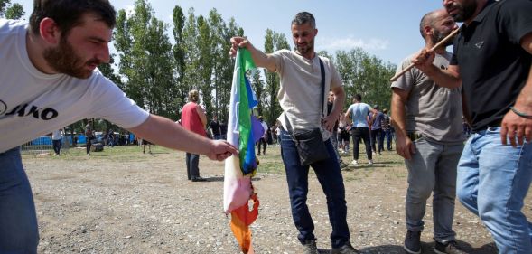A group of anti-LGBTQ+ protestors stormed Tbilisi Pride in Georgia and set fire to rainbow flags.