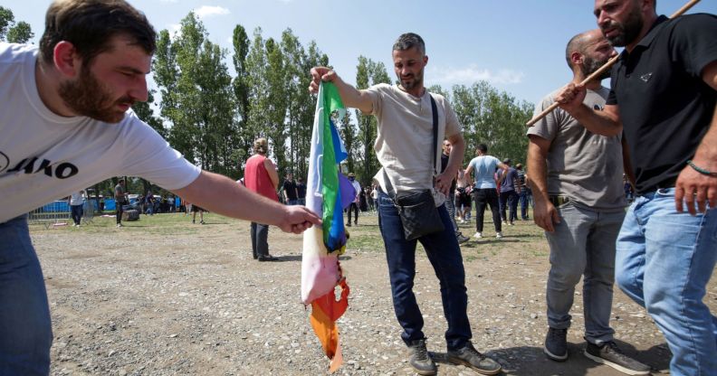 A group of anti-LGBTQ+ protestors stormed Tbilisi Pride in Georgia and set fire to rainbow flags.
