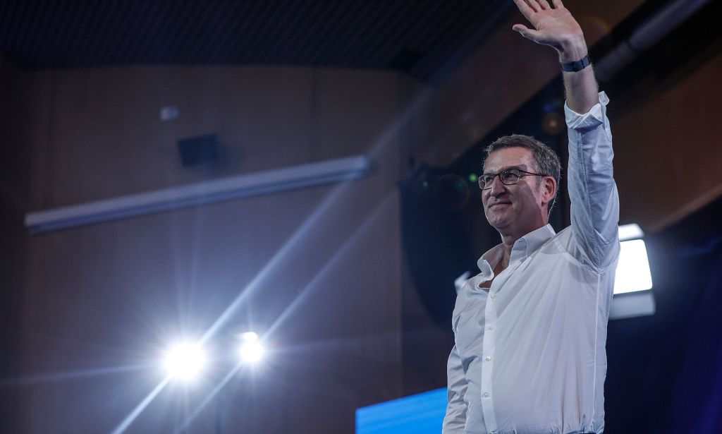 Spanish People's Party leader Alberto Nunez Feijoo waves to a crowd off screen while at a political rally in Spain