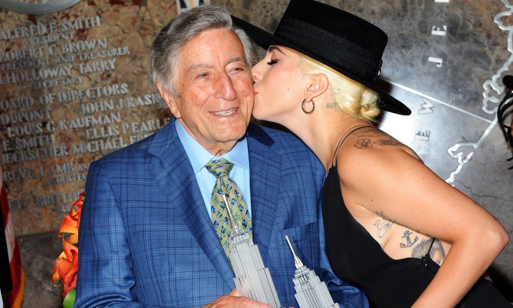Singer Tony Bennett smiles as he gets a kiss on the cheek from Lady Gaga 