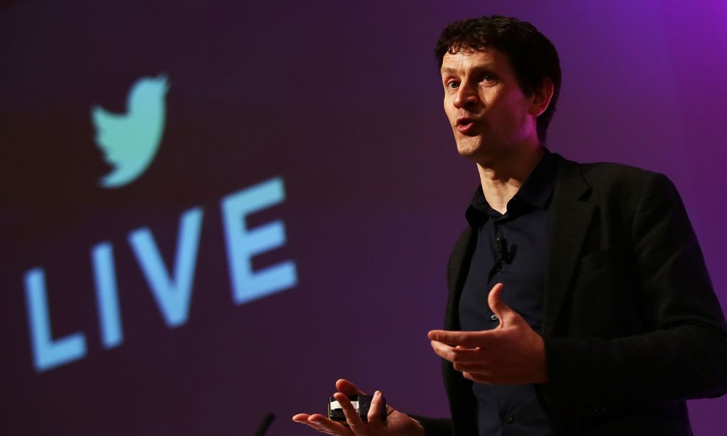 Bruce Daisley, pictured on a stage with a screen showing the Twitter logo and the word "LIVE."
