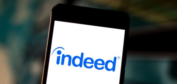 The Indeed.com logo is seen displayed on a smartphone.
