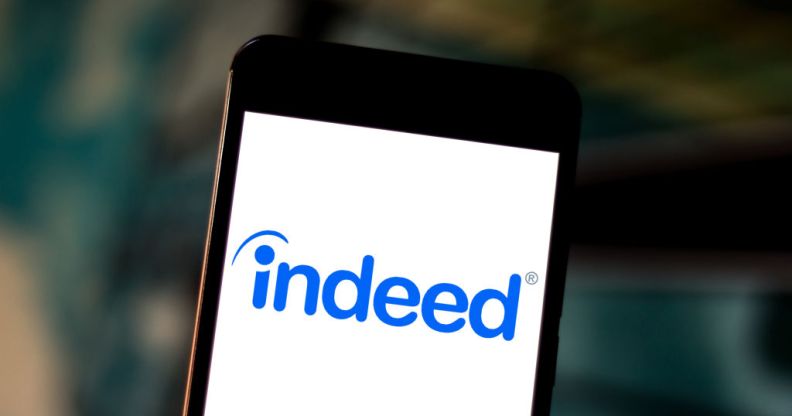 The Indeed.com logo is seen displayed on a smartphone.