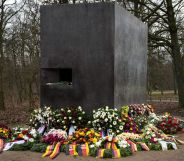 The Tiergarten Holocaust memorial in Berlin, Germany surrounded by flowers.