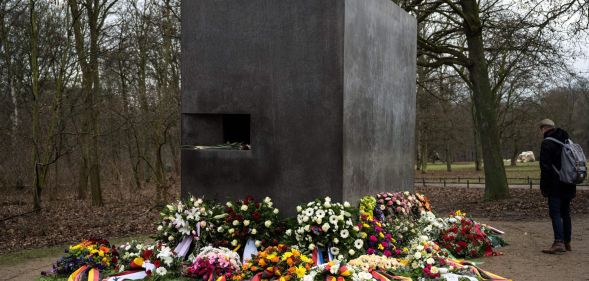The Tiergarten Holocaust memorial in Berlin, Germany surrounded by flowers.