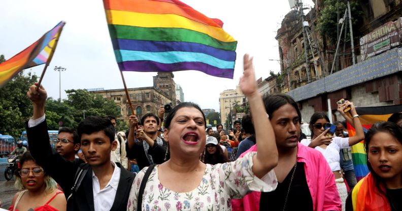 LGBTQ+ activists in India waving LGBTQ+ flags.
