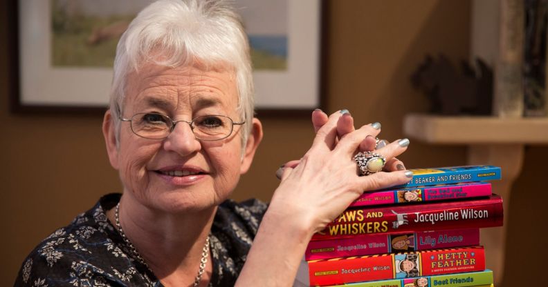 Jacqueline Wilson resting her hands on a pile of her books.