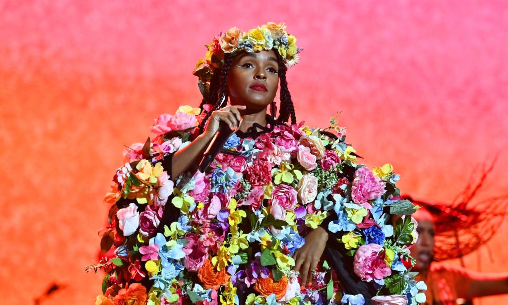 Janelle Monae performs in a dress made out flowers and a flower crown.