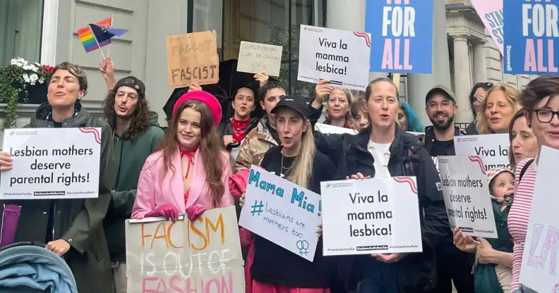 Protestors have rallied in London against Italy’s cruel move to strip lesbian mum’s who did not give birth to their child from birth certificates. 