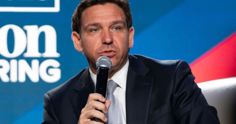 Florida governor Ron DeSantis speaks into a microphone.