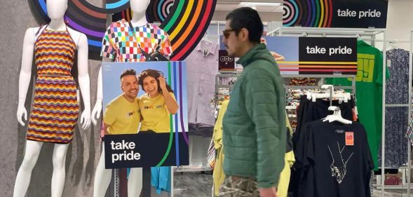 Man walks through a Target store display featuring LGBTQ+ Pride merch