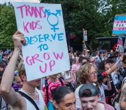 Protester holds up sign reading "trans kids deserve to grow up"