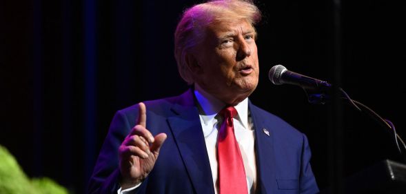 Former US president Donald Trump wears a blue jacket with a red tie