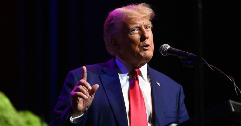 Former US president Donald Trump wears a blue jacket with a red tie