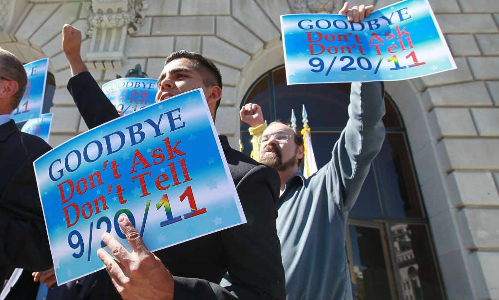 A person holds up a sign saying 'goodbye don't ask don't tell' after a policy preventing LGBTQ+ service members from openly serving in the military was overturned