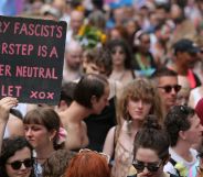 A person holds up a sign reading 'every facist's doorstep is a gender-neutral toilet xxx' during a trans pride protest against anti-trans policies including bathroom bans, restrictions on gender-affirming healthcare and more