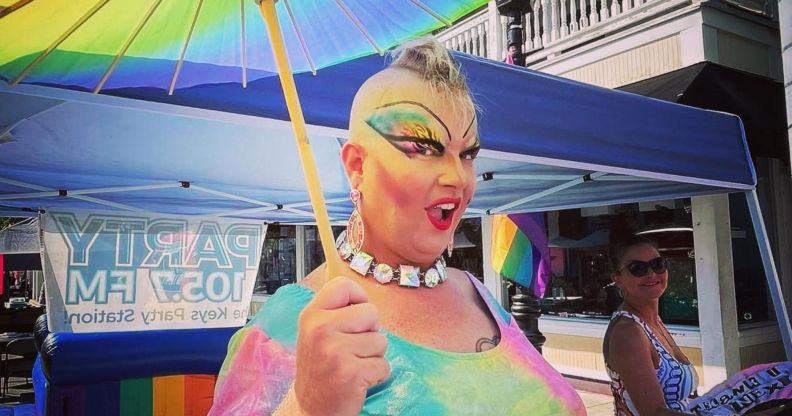 Florida drag queen Michael "Erika Rose" Travis holds up a rainbow umbrella and wears rainbow coloured clothing as she attends an LGBTQ+ event