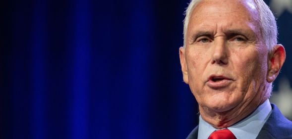 Republican presidential candidate Mike Pence, who has promised to bring back the trans military ban, wears a light blue shirt, red tie and dark jacket as he speaks at an event