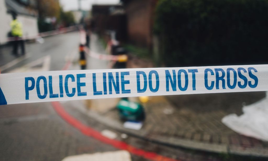 Blue and white tape with the words 'police line do not cross' is used to guard an area where a crime – whether it is a hate crime rooted in homophobia or other attack – by police