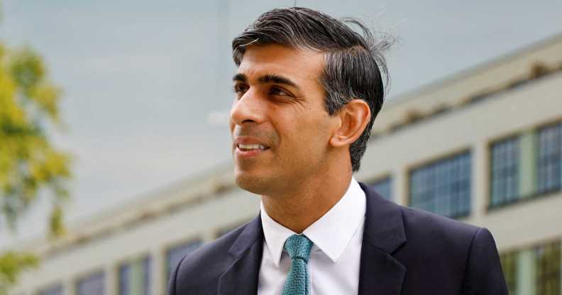 Rishi Sunak pictured outdoors wearing a suit and tie at an event.