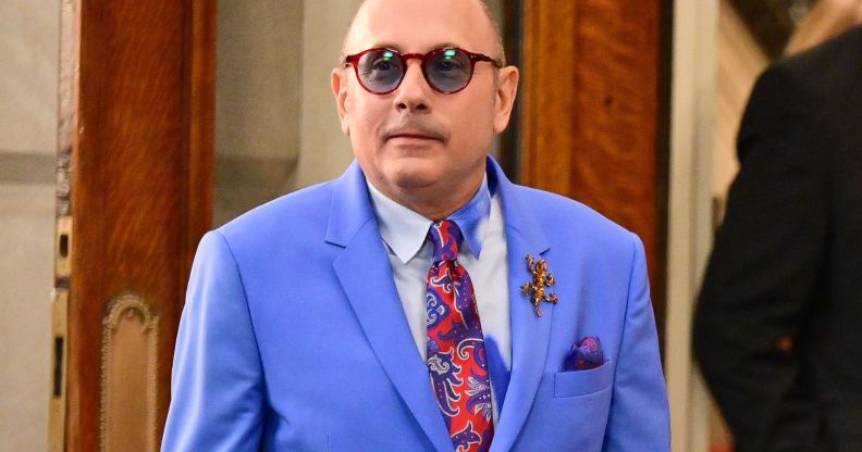 And Just Like That... actor Willie Garson, who played Stanford Blatch, wears a red patterned tie, light shirt and blue jacket while on set