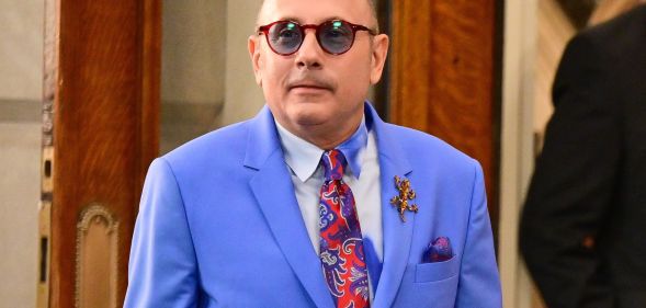 And Just Like That... actor Willie Garson, who played Stanford Blatch, wears a red patterned tie, light shirt and blue jacket while on set