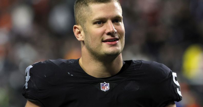 Carl Nassib wearing a football jersey on the pitch.
