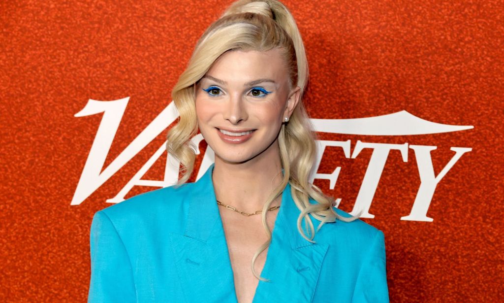 Dylan Mulvaney pictured at a red carpet event infront of a Variety sign.