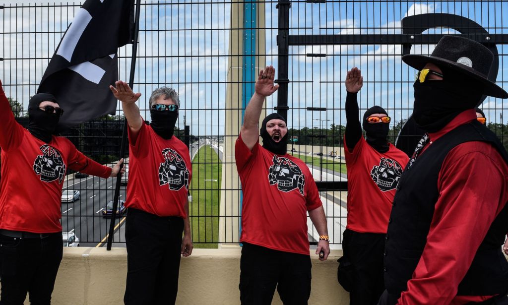 Neo-Nazi members doing the nazi salute outside in Florida.