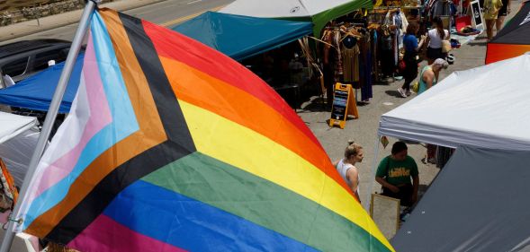 An LGBTQ+ flag waving above a market in Ohio.